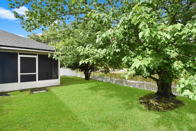a view of house with backyard