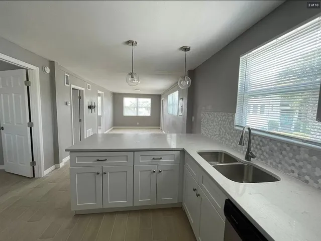 a kitchen with a sink stove and cabinets
