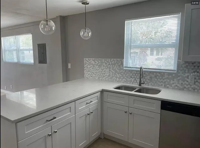 a kitchen with a sink and cabinets