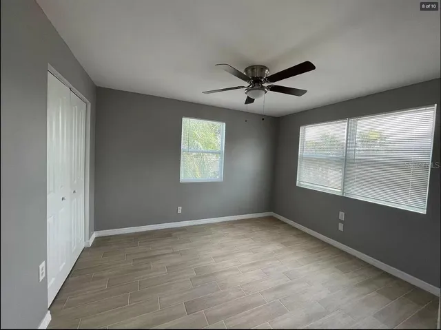 a view of room with a ceiling fan and window