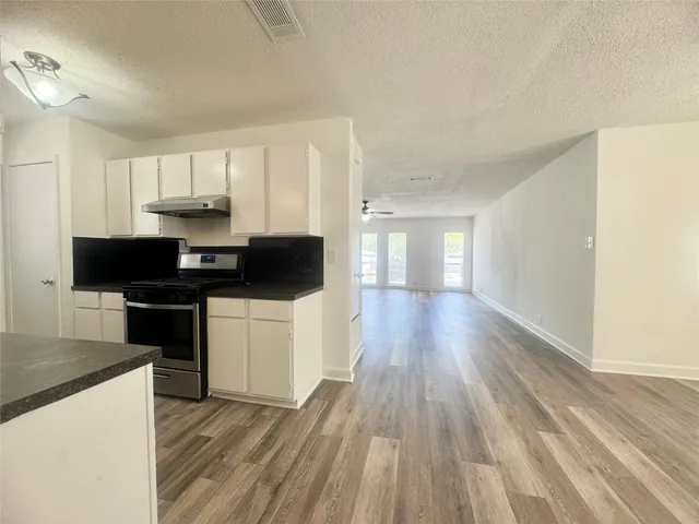 a view of kitchen with cabinets and wooden floor