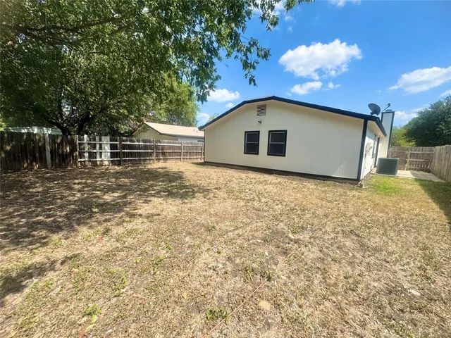 a big room with yard and large trees
