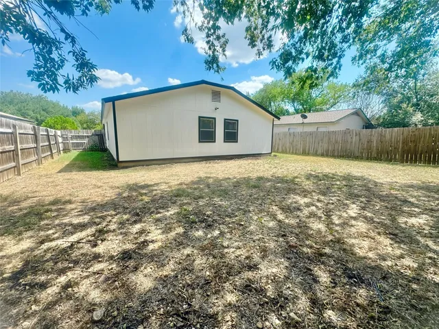 a house with green field in front of it