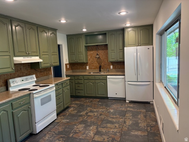 2313 150 East Bountiful, UT 84010 - Photo 8 of 39 Kitchen featuring green cabinetry, mosaic tile backsplash, solid surface countertops, and recessed lighting