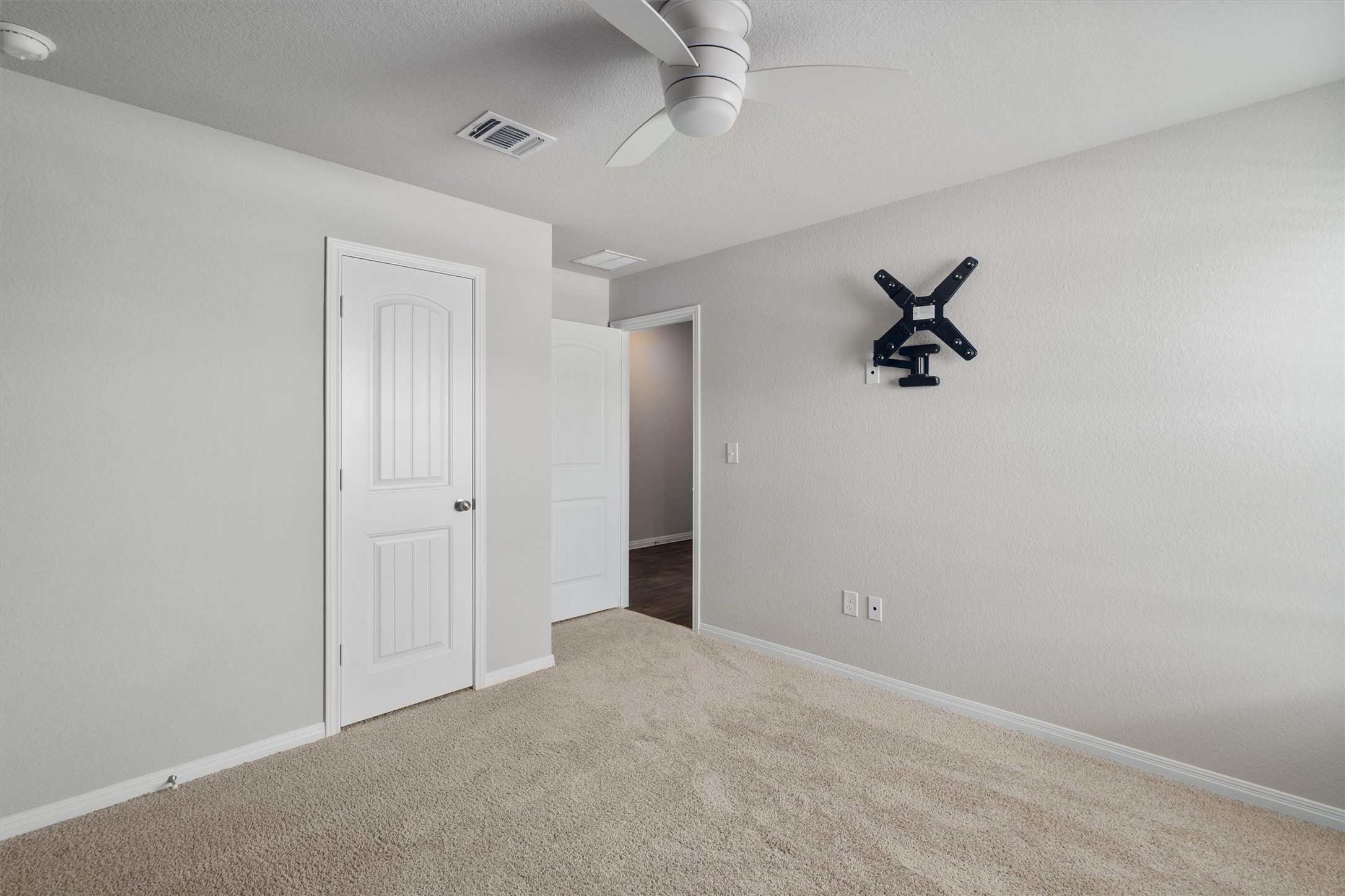 19525 Abigail Fillmore Road Manor, TX 78653 - Photo 23 of 38 A well-proportioned bedroom with soft carpet and a clean, neutral palette awaits your personal touch.