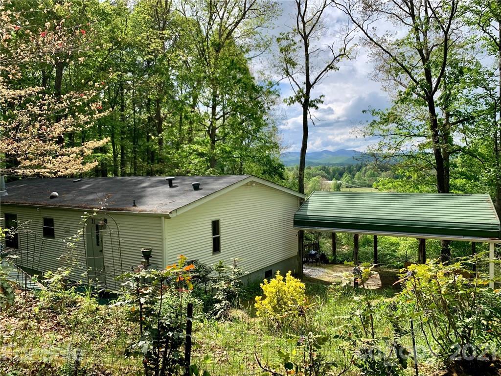 21 Azalea Ridge Road Hendersonville, NC 28739 - Photo 2 of 4 a backyard of a house with lots of green space and fountain