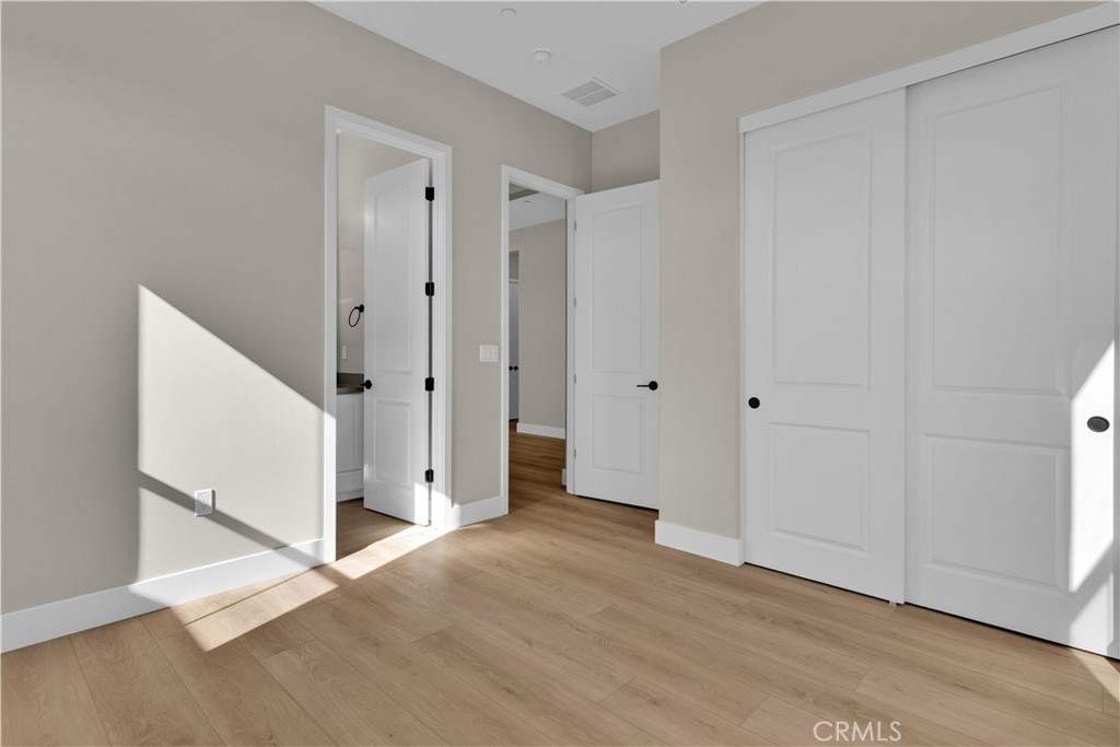 3731 Siembra Road Paso Robles, CA 93446 - Photo 16 of 21 an empty room with wooden floor and white walls