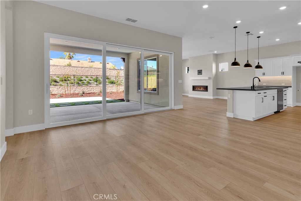 3731 Siembra Road Paso Robles, CA 93446 - Photo 7 of 21 a large kitchen with stainless steel appliances a large counter top a stove a chimney wooden floor and a large window