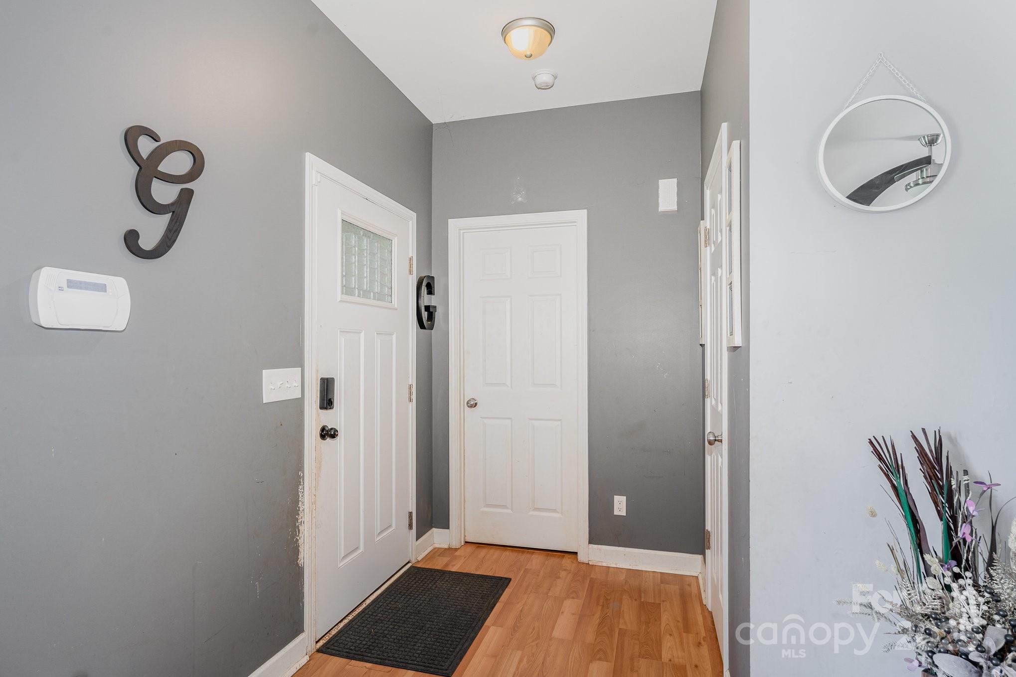 4242 Lake Ridge Court Ramseur, NC 27316 - Photo 11 of 33 a view of room with walk in closet and wooden floor