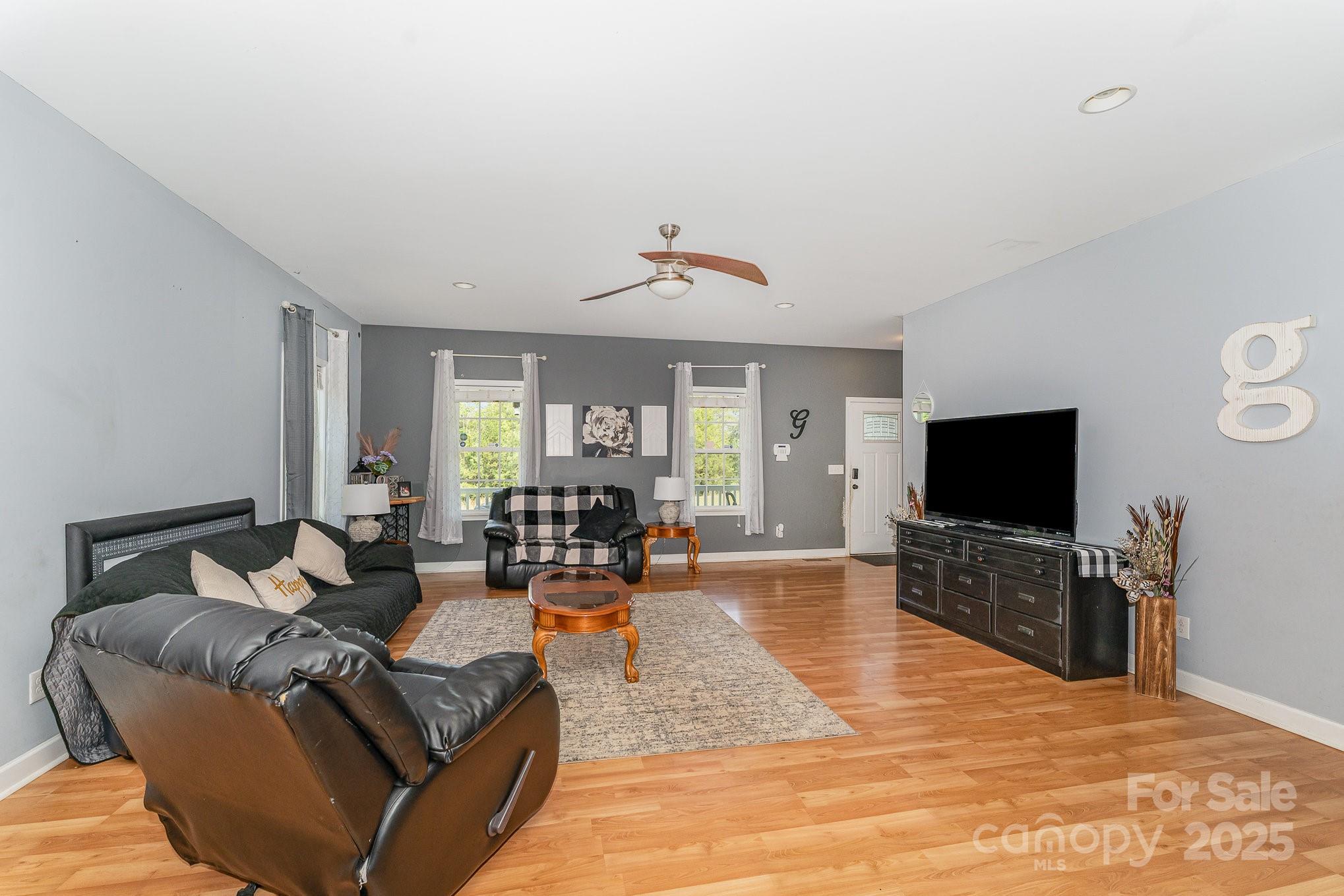 4242 Lake Ridge Court Ramseur, NC 27316 - Photo 14 of 33 a living room with fireplace furniture and a flat screen tv