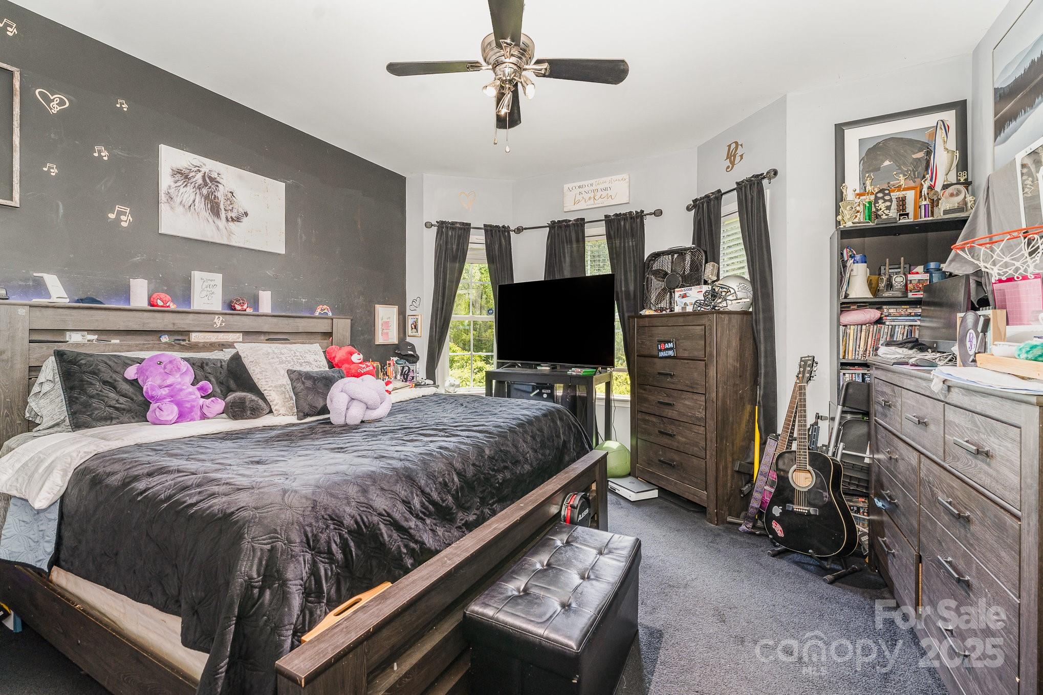 4242 Lake Ridge Court Ramseur, NC 27316 - Photo 22 of 33 a bedroom with a bed and flat screen tv