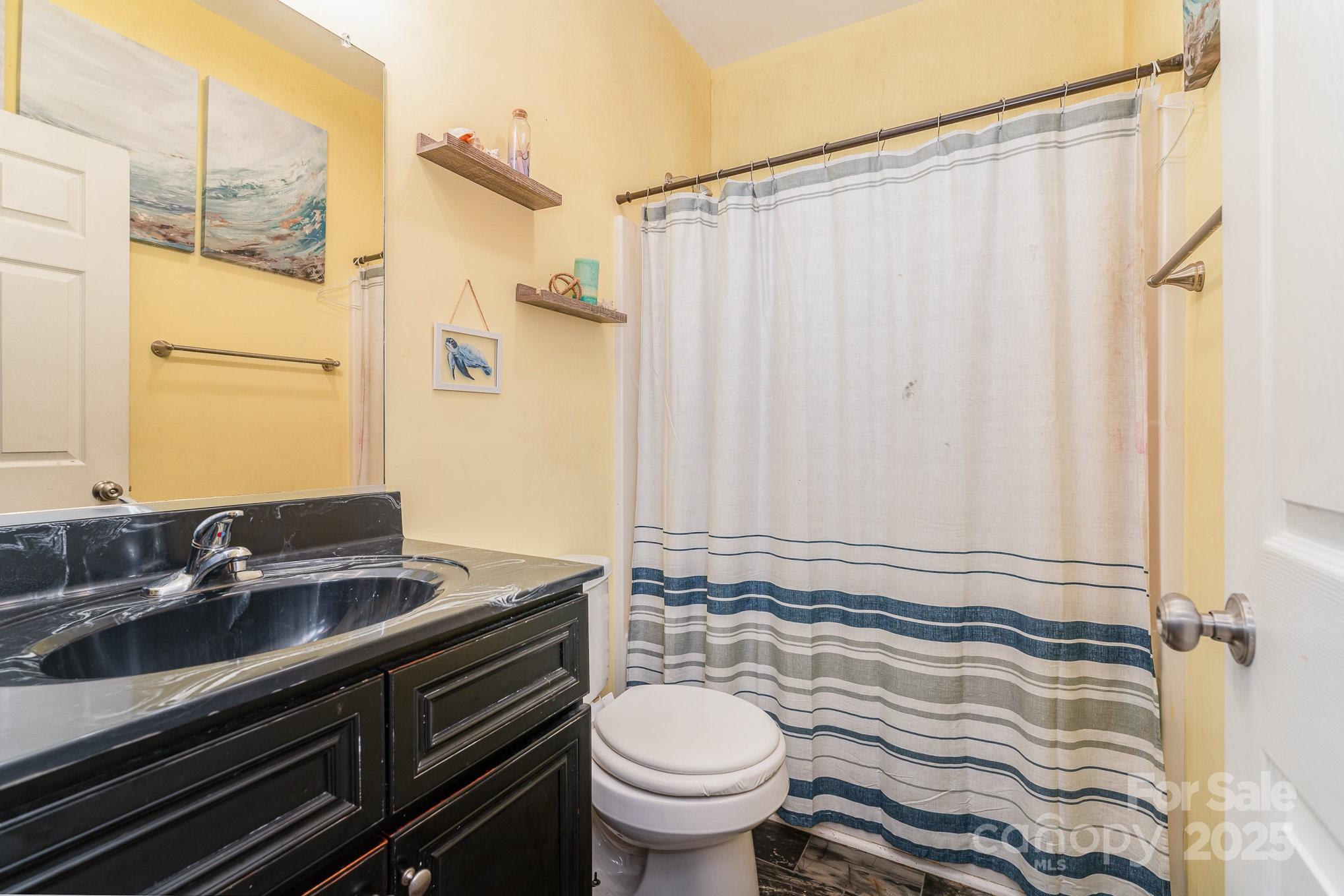 4242 Lake Ridge Court Ramseur, NC 27316 - Photo 25 of 33 a bathroom with a granite countertop sink toilet and shower