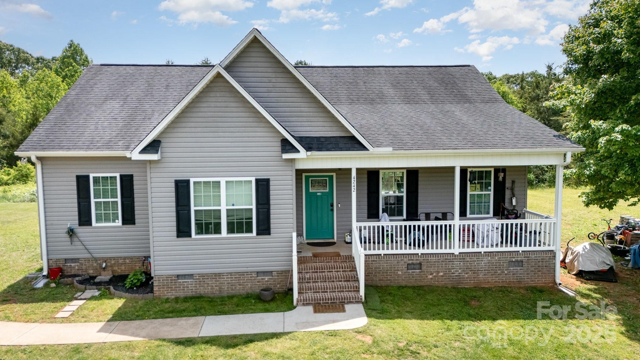 4242 Lake Ridge Court Ramseur, NC 27316 - Photo 5 of 33 a front view of a house with a yard
