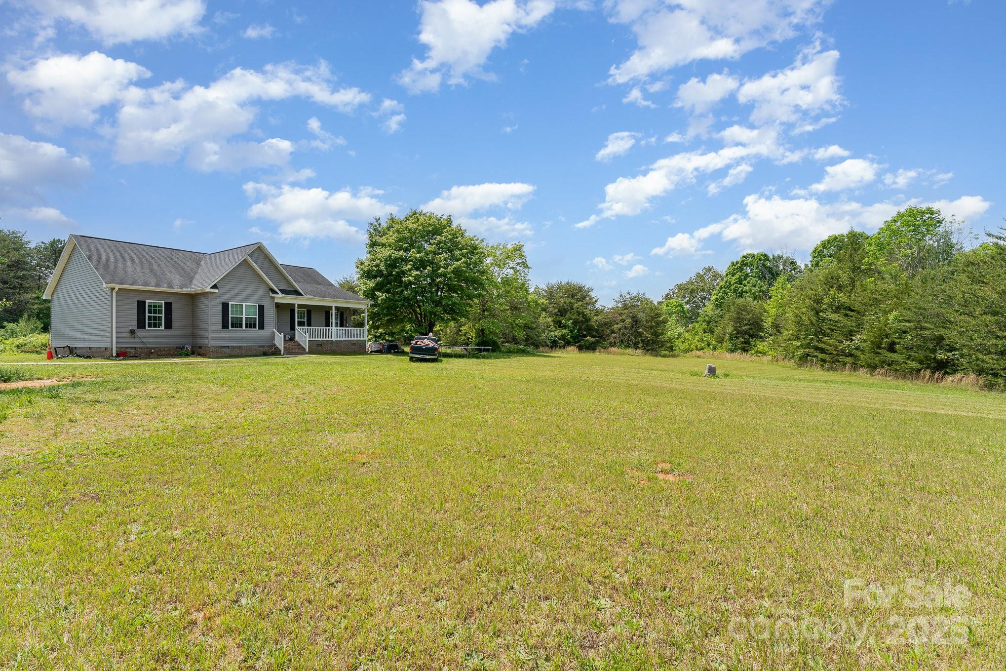 4242 Lake Ridge Court Ramseur, NC 27316 - Photo 7 of 33 a house view with swimming pool and trees in the background