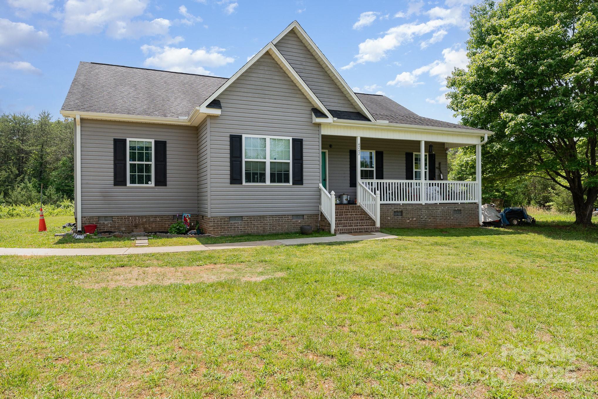 4242 Lake Ridge Court Ramseur, NC 27316 - Photo 9 of 33 a front view of a house with a garden