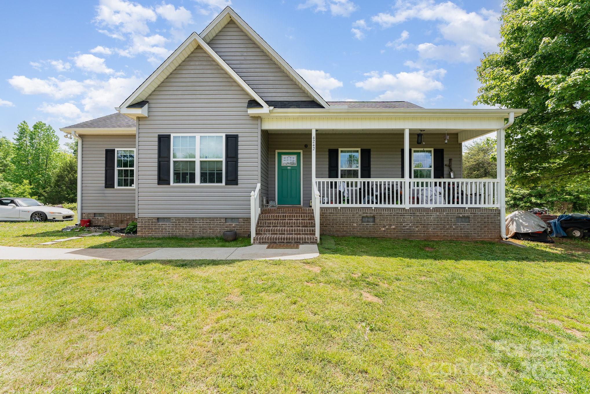 4242 Lake Ridge Court Ramseur, NC 27316 - Photo 10 of 33 a front view of house with yard and glass windows