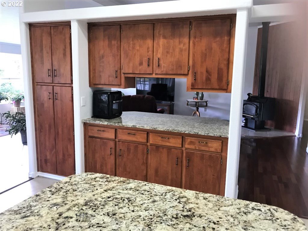56246 Baker Road Coquille, OR 97423 - Photo 17 of 31 a kitchen with a stove and a wooden cabinets