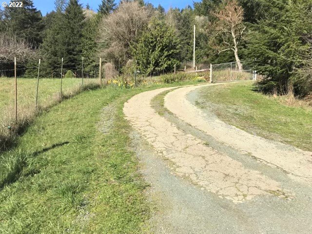 56246 Baker Road Coquille, OR 97423 - Photo 10 of 31 a view of a backyard with swimming pool