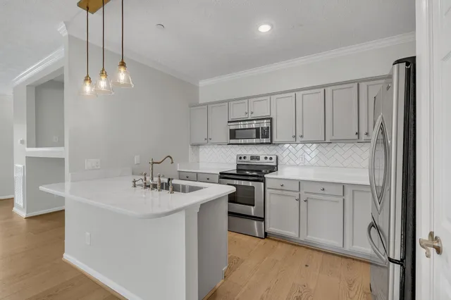 a kitchen with stainless steel appliances granite countertop a sink stove and refrigerator