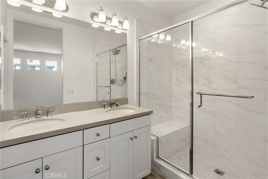 421 Maravilla Lane Brea, CA 92823 - Photo 16 of 22 a bathroom with a granite countertop sink a mirror a vanity and shower