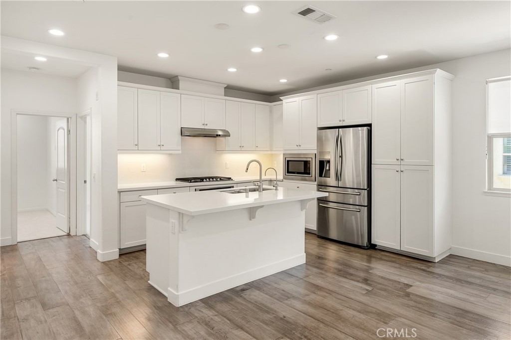 421 Maravilla Lane Brea, CA 92823 - Photo 8 of 22 a kitchen with stainless steel appliances granite countertop a refrigerator and a stove top oven