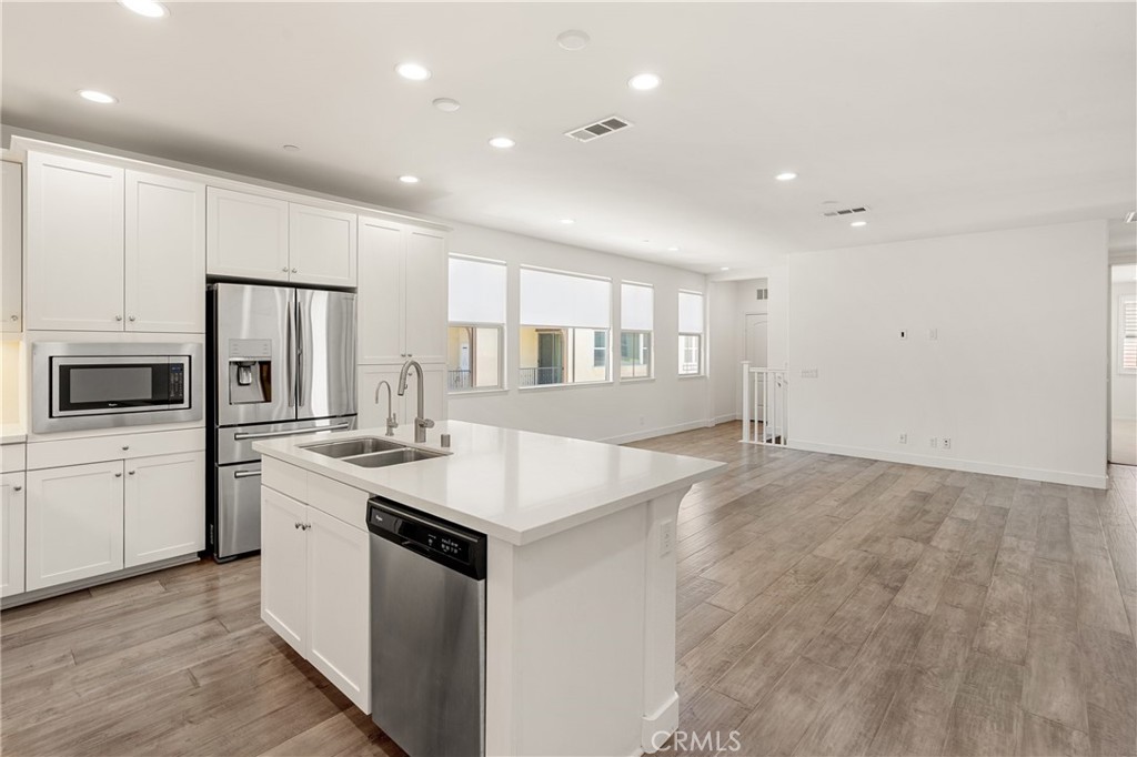 421 Maravilla Lane Brea, CA 92823 - Photo 10 of 22 a kitchen with stainless steel appliances a stove top oven a sink and a refrigerator