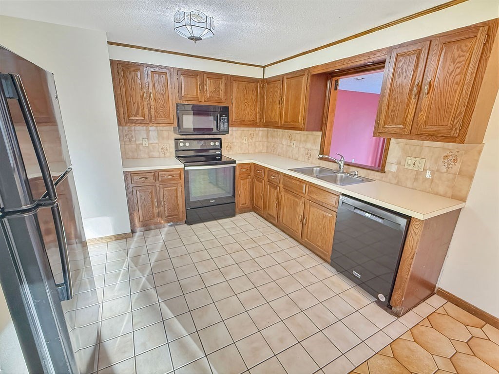 8 Cheney Drive Hudson, NH 03051 - Photo 15 of 42 a kitchen with stainless steel appliances a refrigerator sink and cabinets
