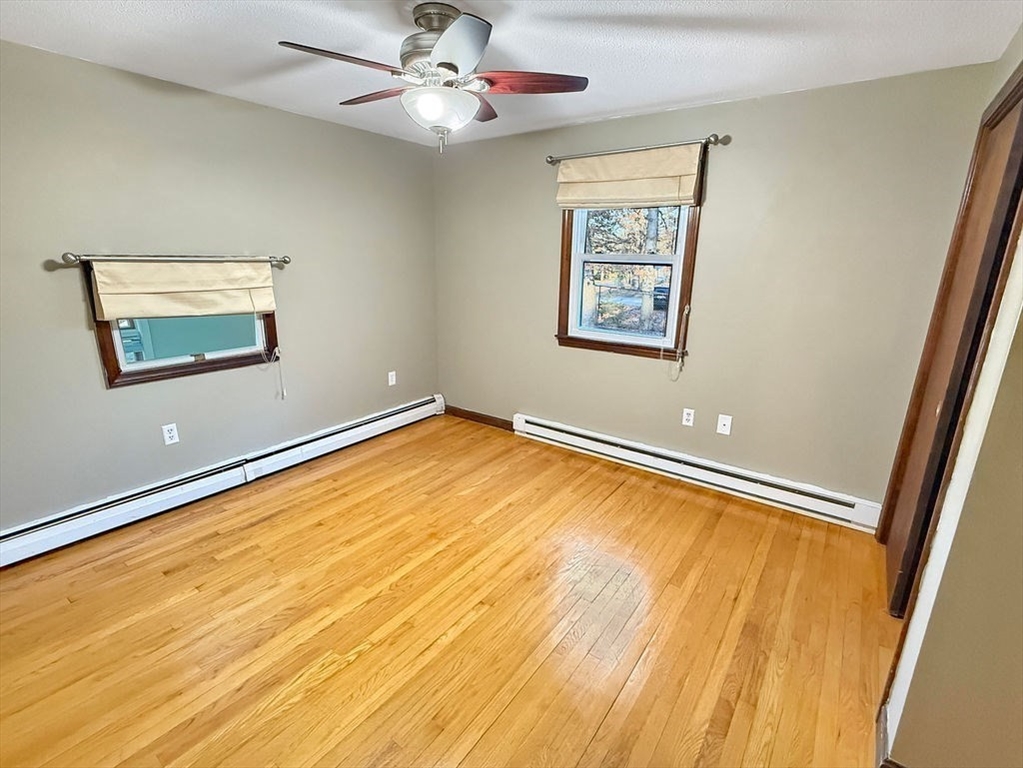 8 Cheney Drive Hudson, NH 03051 - Photo 25 of 42 a view of a room with wooden floor and a ceiling fan