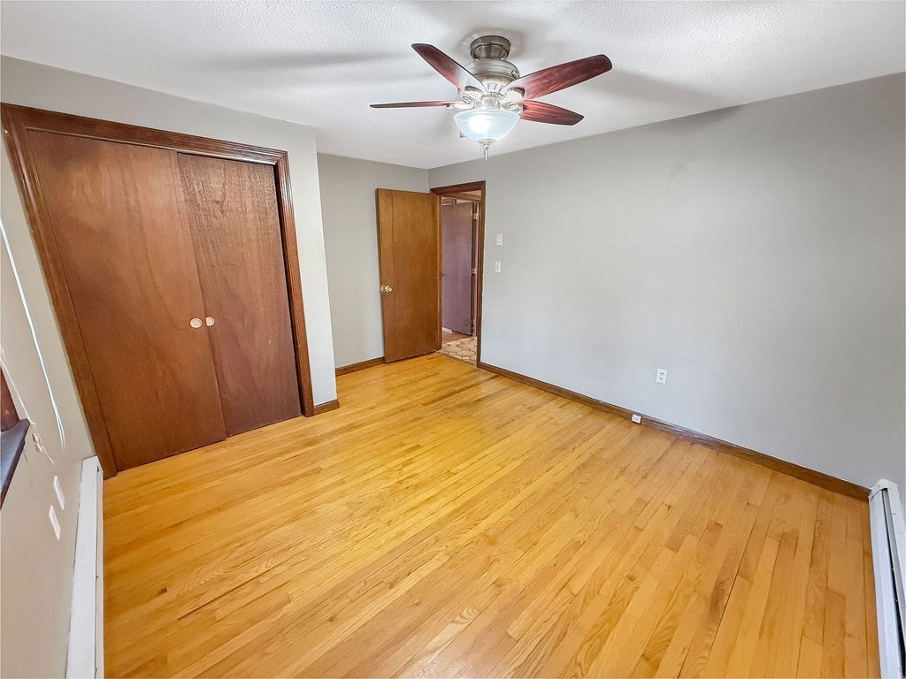 8 Cheney Drive Hudson, NH 03051 - Photo 26 of 42 a big room with wooden floor and a ceiling fan