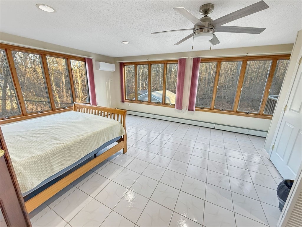 8 Cheney Drive Hudson, NH 03051 - Photo 29 of 42 a bedroom with a large bed and a large window