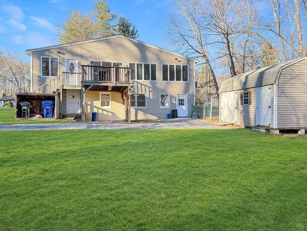 8 Cheney Drive Hudson, NH 03051 - Photo 5 of 42 a front view of a house with a garden and trees