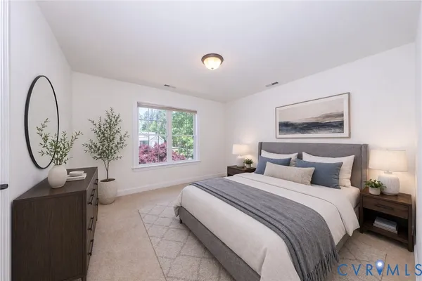 a spacious bedroom with a bed and a large window