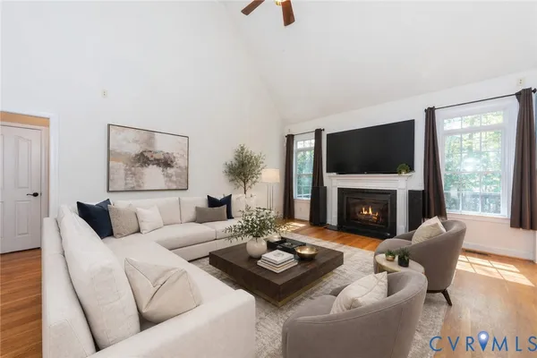 a living room with furniture a fireplace and a flat screen tv
