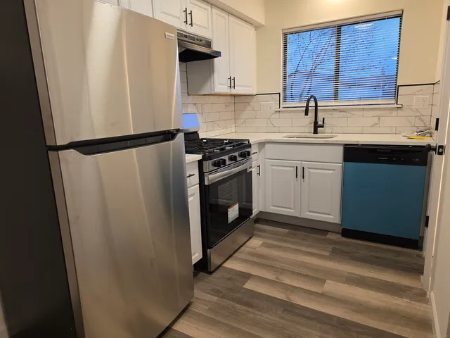 a kitchen with a sink cabinets and appliances