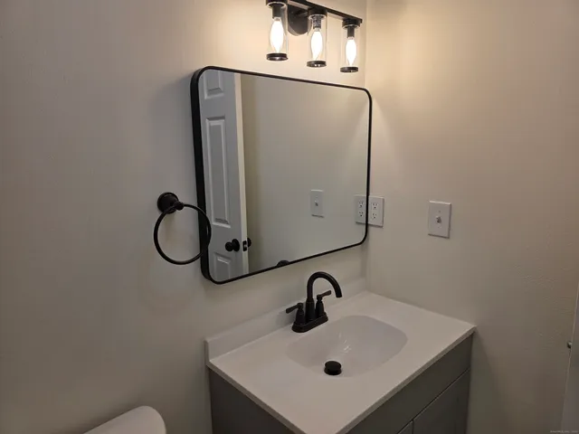 a bathroom with a sink and mirror