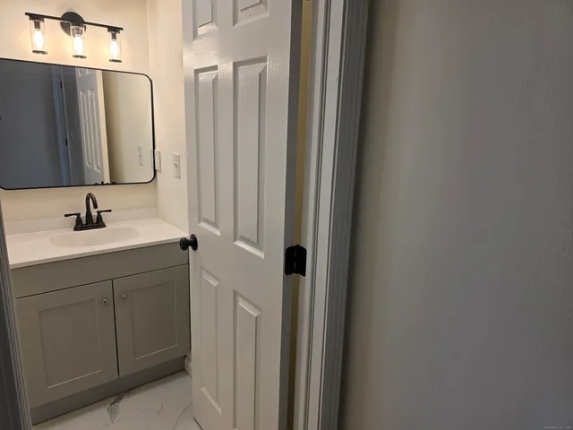 a bathroom with a sink vanity and mirror
