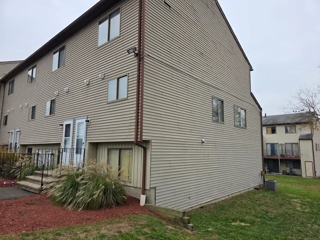 a view of a house with a yard and plants