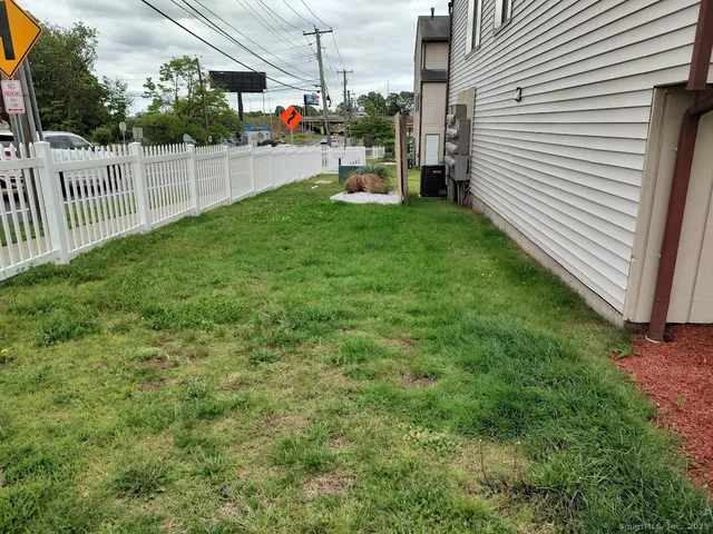 a view of a backyard with sitting area and fence