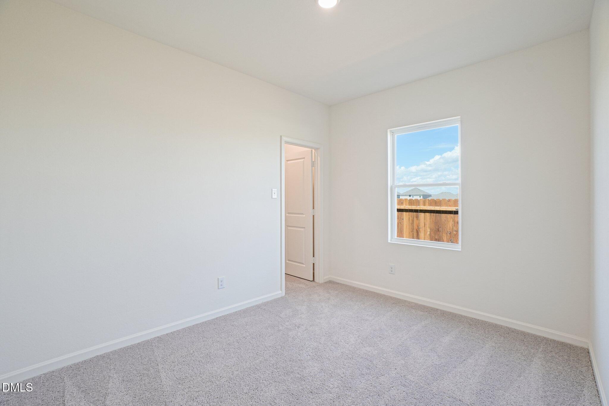 1316 Solace Way Rolesville, NC 27571 - Photo 17 of 29 a view of an empty room with a window