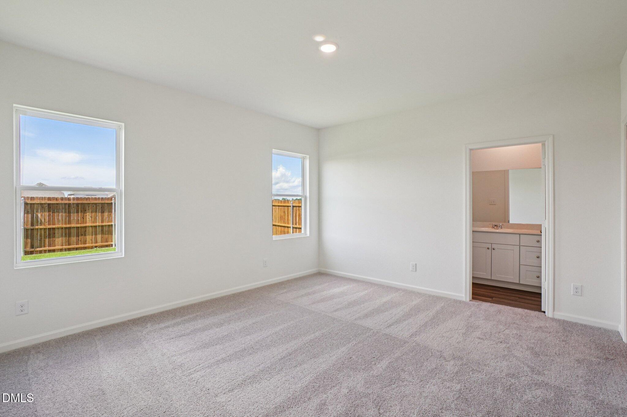 1316 Solace Way Rolesville, NC 27571 - Photo 20 of 29 an empty room with windows and closet
