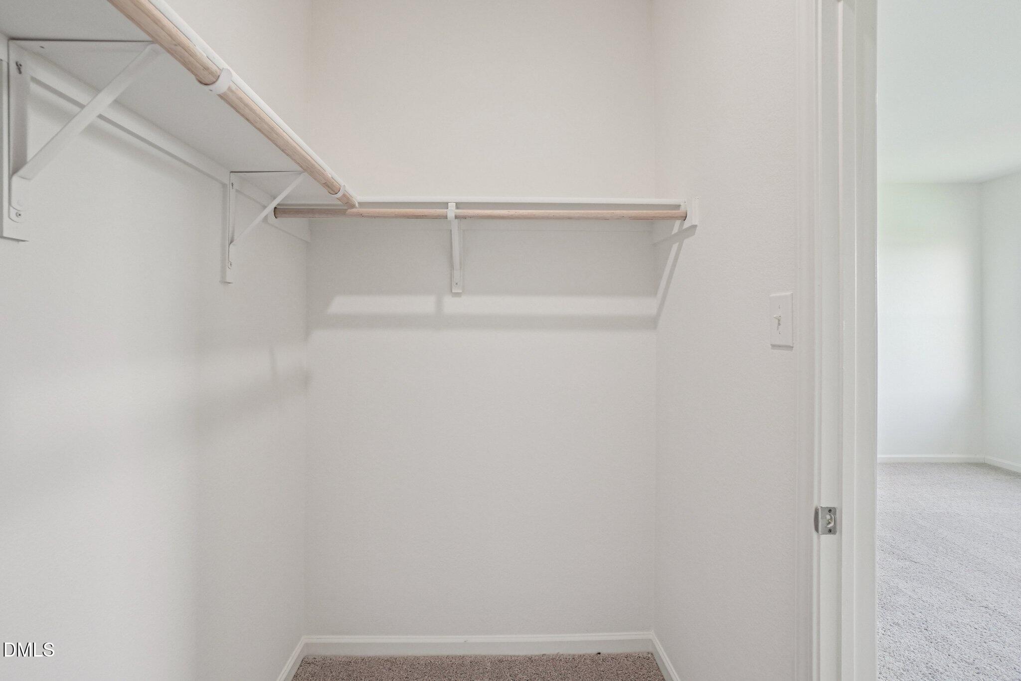 1316 Solace Way Rolesville, NC 27571 - Photo 23 of 29 a view of walk in closet with empty racks
