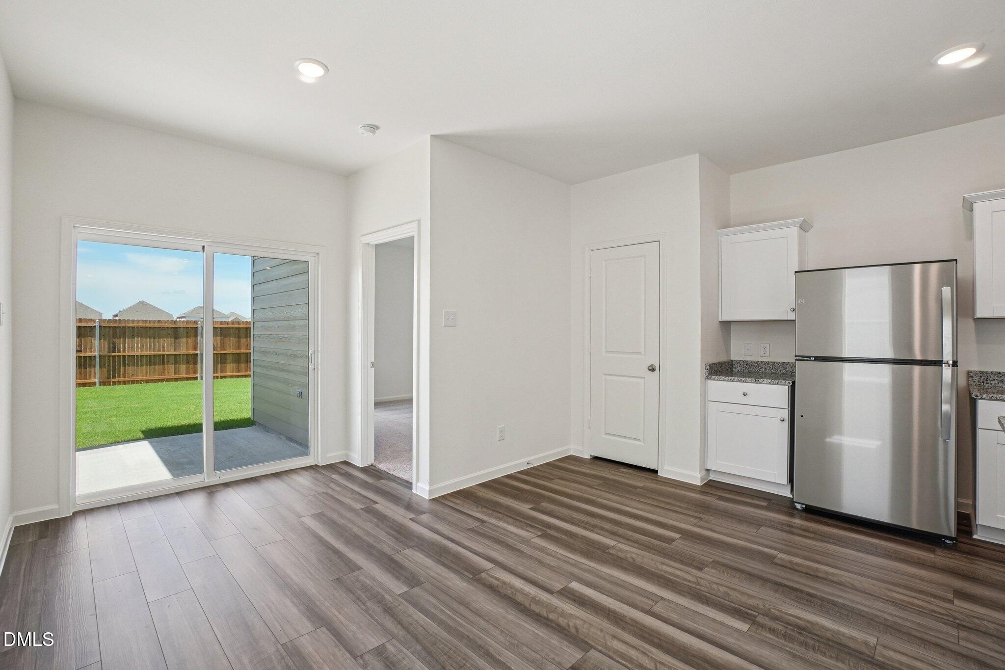 1316 Solace Way Rolesville, NC 27571 - Photo 9 of 29 a view of empty room with wooden floor and fan