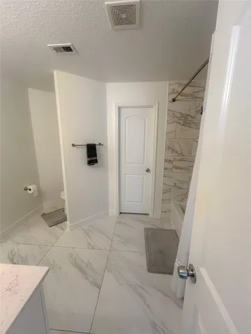 a bathroom with a shower and a tub