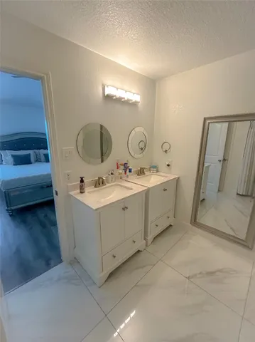 a bedroom with a bed flat screen tv and a couch