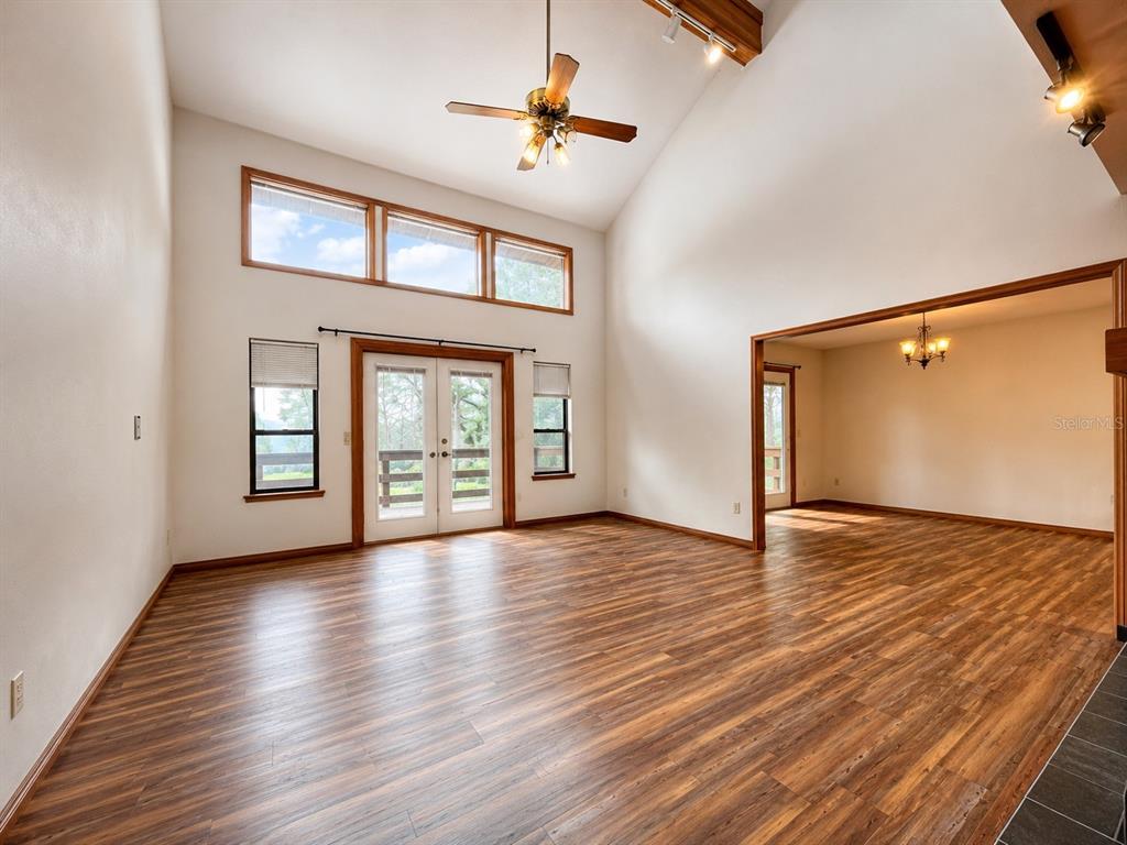 7119 Immokalee Road Keystone Heights, FL 32656 - Photo 9 of 50 a view of an empty room with window and wooden floor