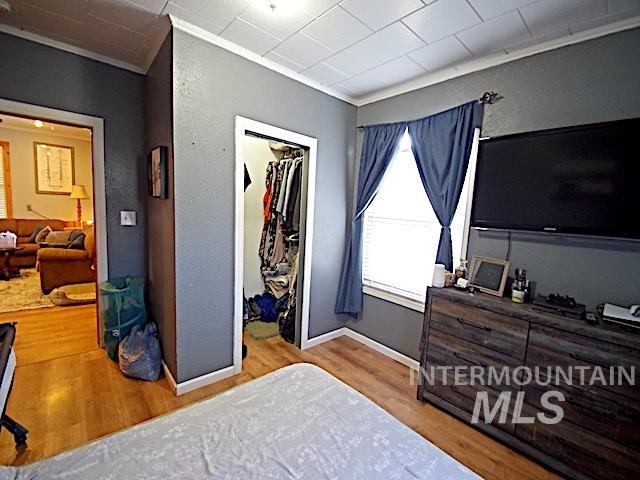 628 3rd Avenue South Payette, ID 83661 - Photo 10 of 19 Bedroom with crown molding, light wood-style flooring, and a spacious closet