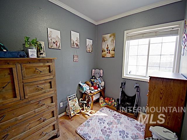 628 3rd Avenue South Payette, ID 83661 - Photo 13 of 19 Bedroom with crown molding and light wood finished floors