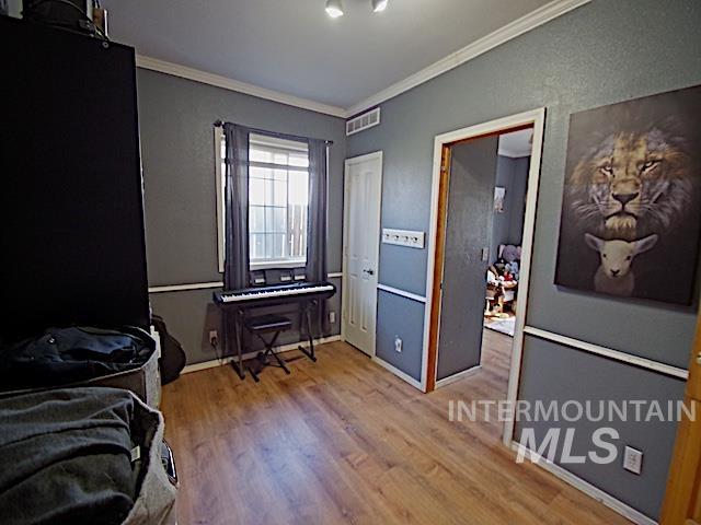 628 3rd Avenue South Payette, ID 83661 - Photo 14 of 19 Bedroom with ornamental molding and light wood-style flooring