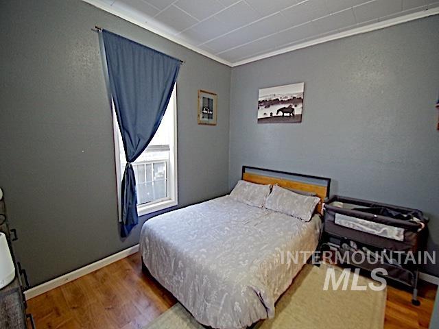 628 3rd Avenue South Payette, ID 83661 - Photo 8 of 19 Bedroom with light wood-style floors and crown molding