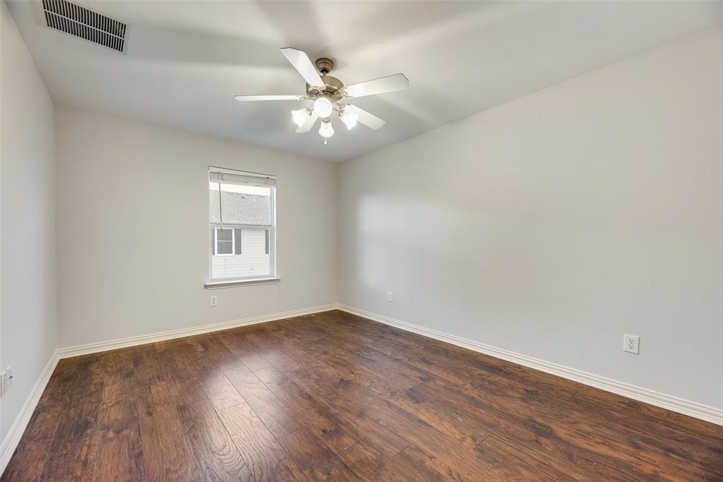 2320 Durango Ridge Drive Bedford, TX 76021 - Photo 19 of 21 an empty room with wooden floor fan and windows